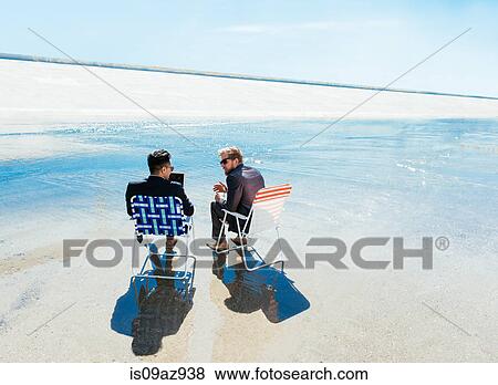 Businessmen sitting in deckchairs on Los Angeles river, California, USA View Large Photo Image Stock Photo - Businessmen sitting in deckchairs on Los Angeles river, California, USA. Fotosearch
