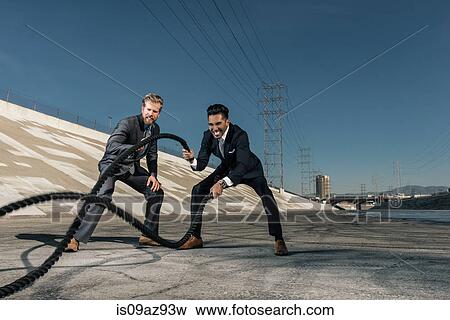 Businessmen using gym ropes, Los Angeles river, California, USA View Large Photo Image Stock Photo - Businessmen using gym ropes, Los Angeles river, California, USA. Fotosearch