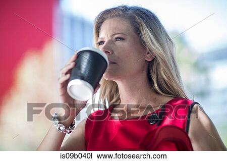 Businesswoman drinking takeaway coffee in city View Large Photo Image Stock Image - Businesswoman drinking takeaway coffee in city. Fotosearch