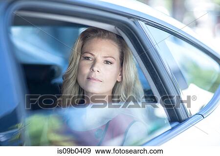 Businesswoman looking out of car window View Large Photo Image Stock Photo - Businesswoman looking out of car window. Fotosearch