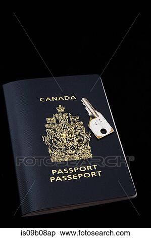 Stock Photography - Canadian passport and key on black background. Fotosearch