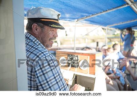 Captain steering on tourist boat trip, Cape Town, South Africa View Large Photo Image Stock Image - Captain steering on tourist boat trip, Cape Town, South Africa. Fotosearch