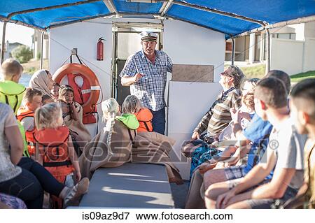 Captain talking to tourists on boat trip, Cape Town, South Africa View Large Photo Image Stock Photo - Captain talking to tourists on boat trip, Cape Town, South Africa. Fotosearch