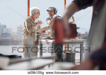Carpenters having discussion in furniture making workshop View Large Photo Image Stock Image - Carpenters having discussion in furniture making workshop. Fotosearch
