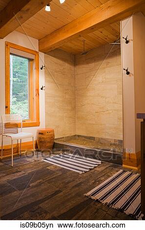 Ceramic shower in bathroom on ground floor of cottage-style log cabin, Quebec, Canada View Large Photo Image Picture - Ceramic shower in bathroom on ground floor of cottage-style log cabin, Quebec, Canada. Fotosearch