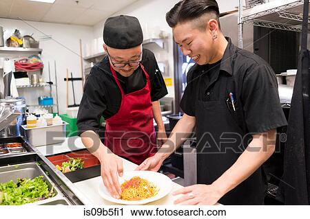 Chefs in kitchen preparing food View Large Photo Image Stock Image - Chefs in kitchen preparing food. Fotosearch