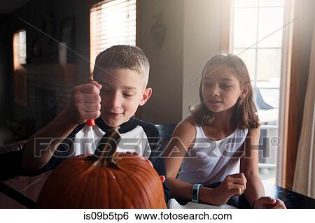 Children carving pumpkin View Large Photo Image Stock Photograph - Children carving pumpkin. Fotosearch