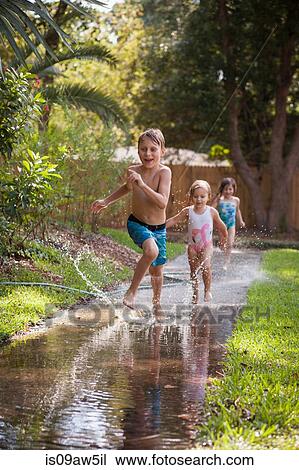 Children running in water on sidewalk View Large Photo Image Stock Image - Children running in water on sidewalk. Fotosearch