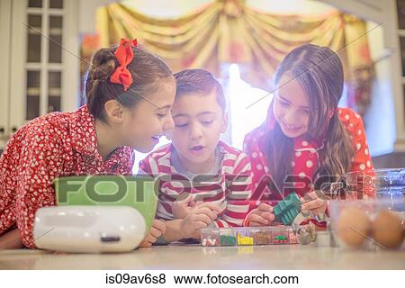 Children wearing pyjamas at kitchen counter discussing cake decorations View Large Photo Image Stock Photo - Children wearing pyjamas at kitchen counter discussing cake decorations. Fotosearch