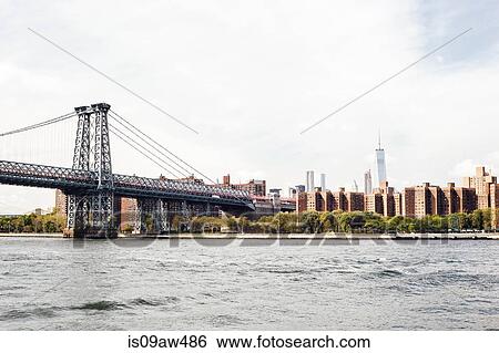 Cityscape of Williamsburg Bridge over East river with Freedom Tower, New York, USA View Large Photo Image Stock Photograph - Cityscape of Williamsburg Bridge over East river with Freedom Tower, New York, USA. Fotosearch