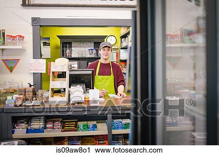 Stock Image - Clerk in general store, Hague, USA. Fotosearch