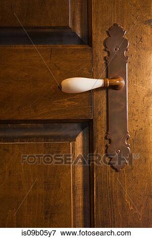 Close-up of a white porcelain door handle on old wooden door of master bedroom in cottage style log home, Quebec, Canada View Large Photo Image Stock Photo - Close-up of a white porcelain door handle on old wooden door of master bedroom in cottage style log home, Quebec, Canada. Fotosearch