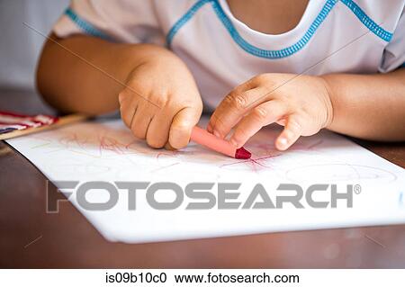 Close up of baby boys hands crayon drawing at dining room table View Large Photo Image Stock Image - Close up of baby boys hands crayon drawing at dining room table. Fotosearch