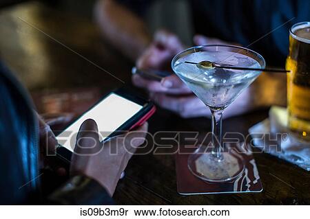 Close up of female hand using smartphone in public house View Large Photo Image Stock Photography - Close up of female hand using smartphone in public house. Fotosearch
