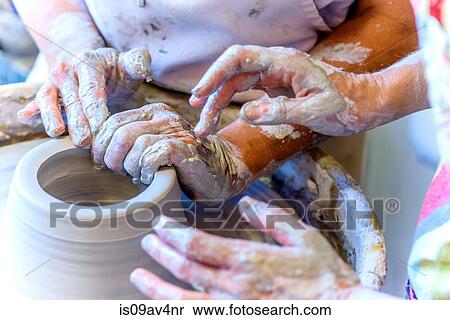 Close up of female potter and mature student hands making pot on potters wheel View Large Photo Image Stock Photography - Close up of female potter and mature student hands making pot on potters wheel. Fotosearch