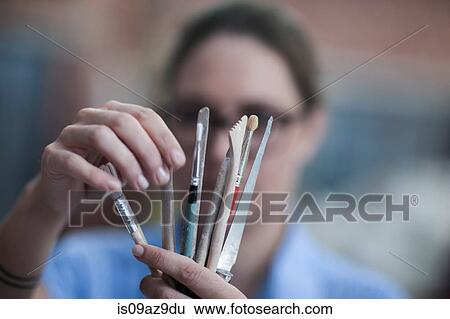 Close up of female potters hand selecting tool in workshop View Large Photo Image Stock Photograph - Close up of female potters hand selecting tool in workshop. Fotosearch