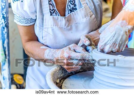 Close up of hands of female potter and mature student making pot on potters wheel View Large Photo Image Stock Photograph - Close up of hands of female potter and mature student making pot on potters wheel. Fotosearch