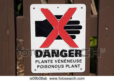 Stock Image - Close up of warning sign on fence. Fotosearch