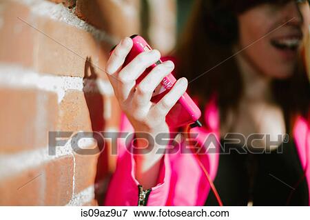 Close up of young womans hand holding smartphone View Large Photo Image Stock Photo - Close up of young womans hand holding smartphone. Fotosearch