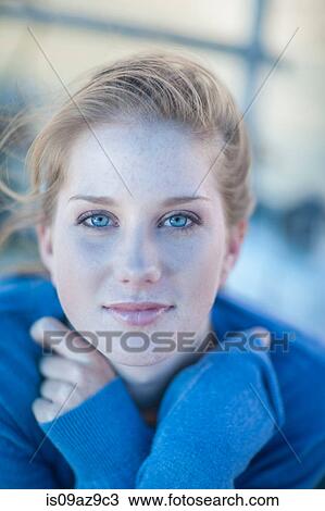 Stock Image - Close up portrait of blue eyed young woman. Fotosearch