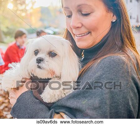 Close up portrait of mature woman carrying dog in arms View Large Photo Image Stock Photograph - Close up portrait of mature woman carrying dog in arms. Fotosearch