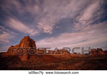 Clouded starry sky and valley rock formations at night, Moab, Utah, USA View Large Photo Image Stock Photo - Clouded starry sky and valley rock formations at night, Moab, Utah, USA. Fotosearch