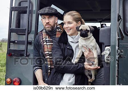Country couple with dog looking out from back door of off road vehicle View Large Photo Image Picture - Country couple with dog looking out from back door of off road vehicle. Fotosearch