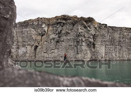 Stock Photography - Couple against background of cliff face, Ottawa, Ontario. Fotosearch