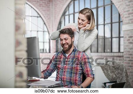 Couple at home, using computer, laughing View Large Photo Image Stock Image - Couple at home, using computer, laughing. Fotosearch