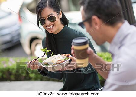 Couple at sidewalk cafe enjoying lunch View Large Photo Image Stock Image - Couple at sidewalk cafe enjoying lunch. Fotosearch