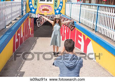 Stock Photo - Couple at tunnel entrance taking photo, Coney island, Brooklyn, New York, USA. Fotosearch