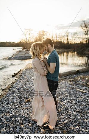 Couple beside lake, face to face, holding hands View Large Photo Image Stock Photography - Couple beside lake, face to face, holding hands. Fotosearch