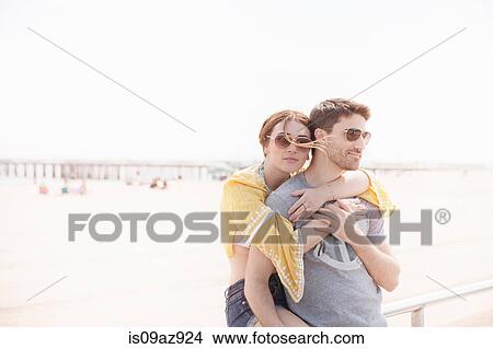 Couple by beach hugging, Coney island, Brooklyn, New York, USA View Large Photo Image Picture - Couple by beach hugging, Coney island, Brooklyn, New York, USA. Fotosearch