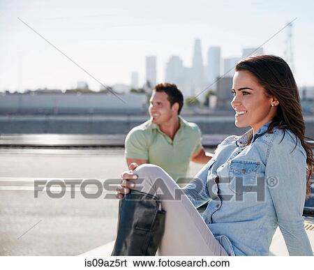 Couple by river looking away smiling View Large Photo Image Stock Photograph - Couple by river looking away smiling. Fotosearch