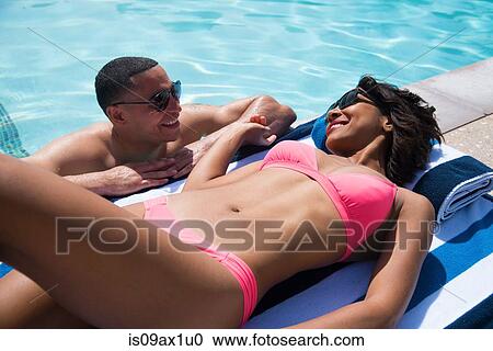 Couple chatting beside pool View Large Photo Image Stock Image - Couple chatting beside pool. Fotosearch