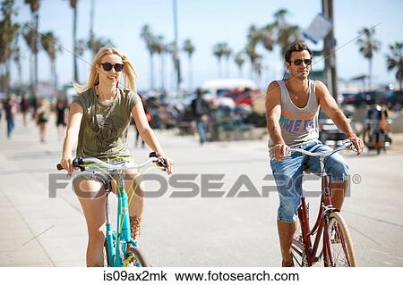 Couple cycling at Venice Beach, Los Angeles, California, USA View Large Photo Image Stock Image - Couple cycling at Venice Beach, Los Angeles, California, USA. Fotosearch
