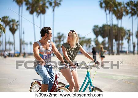 Couple cycling together at Venice Beach, Los Angeles, California, USA View Large Photo Image Stock Photography - Couple cycling together at Venice Beach, Los Angeles, California, USA. Fotosearch