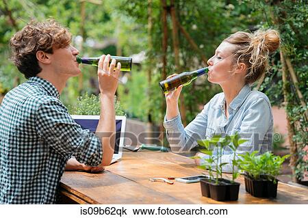 Couple drinking beer in garden View Large Photo Image Stock Image - Couple drinking beer in garden. Fotosearch