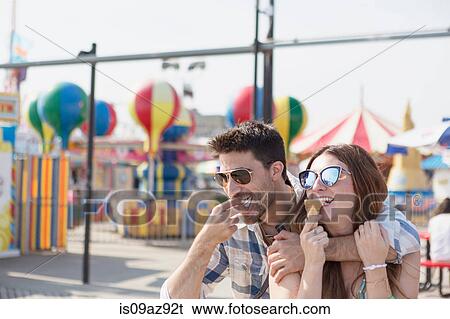 Stock Photograph - Couple eating ice cream cones, Coney island, Brooklyn, New York, USA. Fotosearch