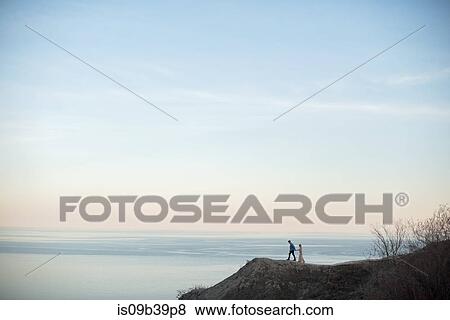 Couple enjoying view on cliff, Ottawa, Ontario View Large Photo Image Stock Photo - Couple enjoying view on cliff, Ottawa, Ontario. Fotosearch