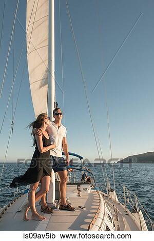 Stock Image - Couple enjoying view on sailboat, San Diego Bay, California, USA. Fotosearch