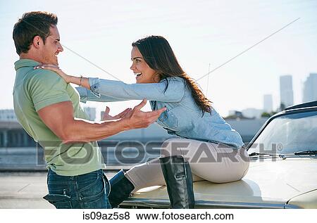 Couple fooling around on car bonnet, Los Angeles, California, USA View Large Photo Image Stock Photo - Couple fooling around on car bonnet, Los Angeles, California, USA. Fotosearch
