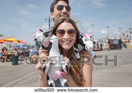 Couple holding cuddly toy cows smiling, Coney island, Brooklyn, New York, USA View Large Photo Image Stock Image - Couple holding cuddly toy cows smiling, Coney island, Brooklyn, New York, USA. Fotosearch