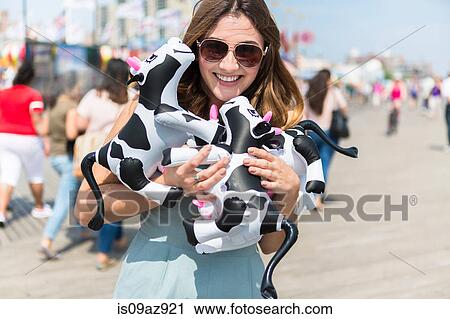 Couple holding cuddly toy cows smiling, Coney island, Brooklyn, New York, USA View Large Photo Image Stock Image - Couple holding cuddly toy cows smiling, Coney island, Brooklyn, New York, USA. Fotosearch