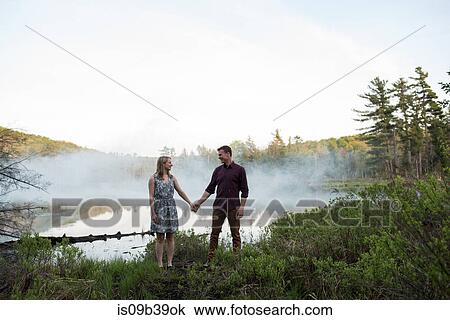Couple holding hands by misty lake, Ottawa, Ontario View Large Photo Image Stock Image - Couple holding hands by misty lake, Ottawa, Ontario. Fotosearch