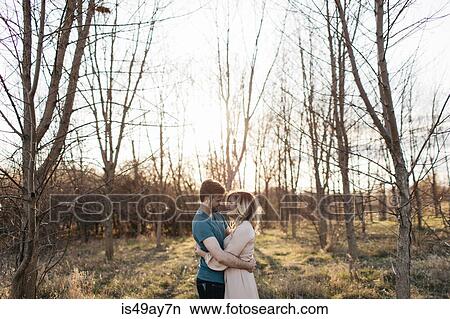 Couple hugging in rural setting View Large Photo Image Picture - Couple hugging in rural setting. Fotosearch