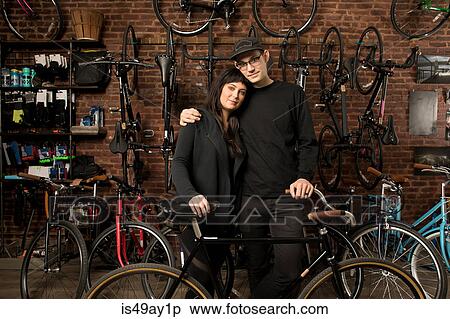 Couple in bicycle shop View Large Photo Image Stock Photography - Couple in bicycle shop. Fotosearch