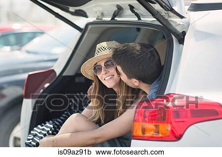 Couple in car boot kissing View Large Photo Image Stock Image - Couple in car boot kissing. Fotosearch