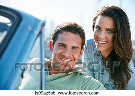 Couple in convertible car looking at camera smiling, Los Angeles, California, USA View Large Photo Image Stock Image - Couple in convertible car looking at camera smiling, Los Angeles, California, USA. Fotosearch