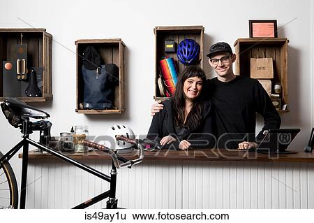 Stock Photograph - Couple in cycling accessories shop. Fotosearch